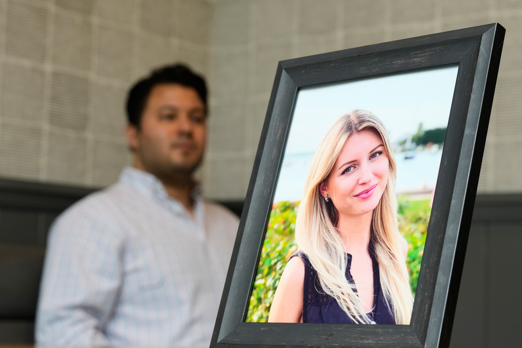 Harold Jezler poses for a picture with a photo of his wife, Olga Jezler, in West Harrison, N.Y., Friday, Aug. 21, 2026. (AP Photo/Seth Wenig)