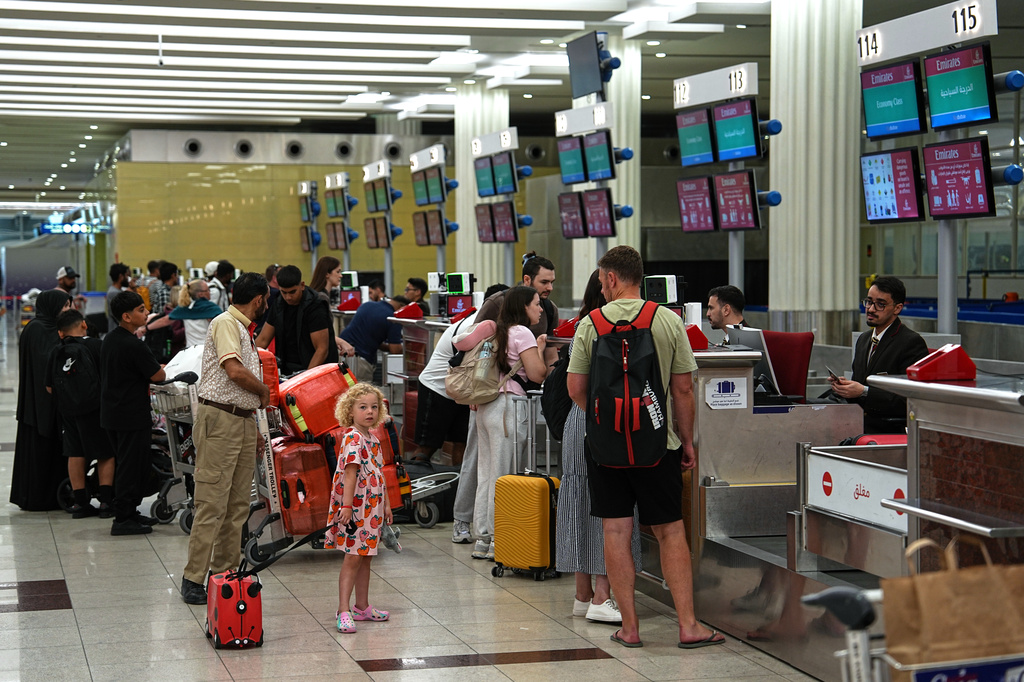 Travelers check in at Terminal 3 of Dubai International Airport in Dubai, United Arab Emirates, Wednesday, Aug. 26, 2026. (AP Photo/ Fatima Shbair)