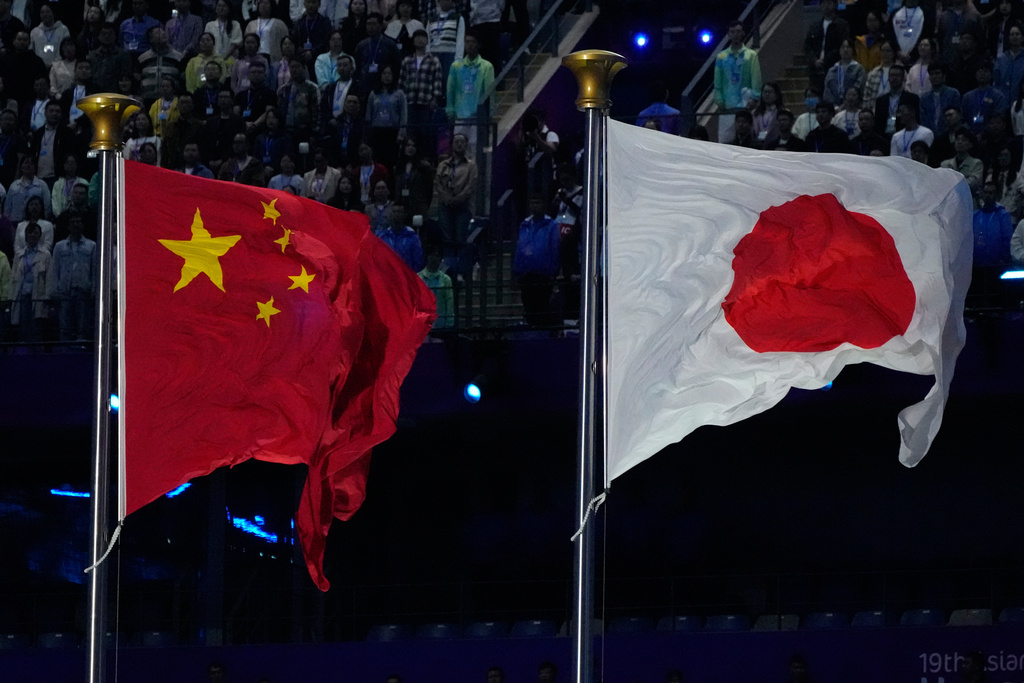 FILE - The flags of China and Japan are flown at the during the handover ceremony from China to Japan the next host of the Asian Games at the closing ceremony of the 19th Asian Games in Hangzhou, China, on Oct. 8, 2023. (AP Photo/Eugene Hoshiko, File)