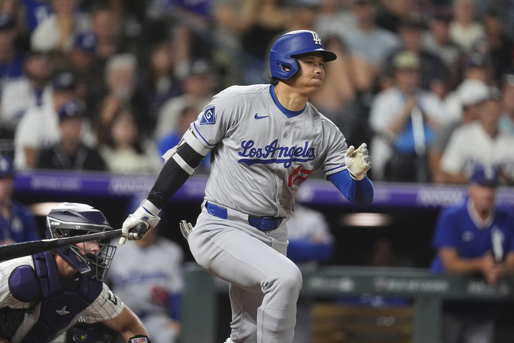 Los Angeles Dodgers; Shohei Ohtani drives in a run while hitting into a force play against Colorado Rockies relief pitcher Nick Anderson in the seventh inning of a baseball game, Tuesday, Aug. 19, 2025, in Denver. (AP Photo/David Zalubowski)