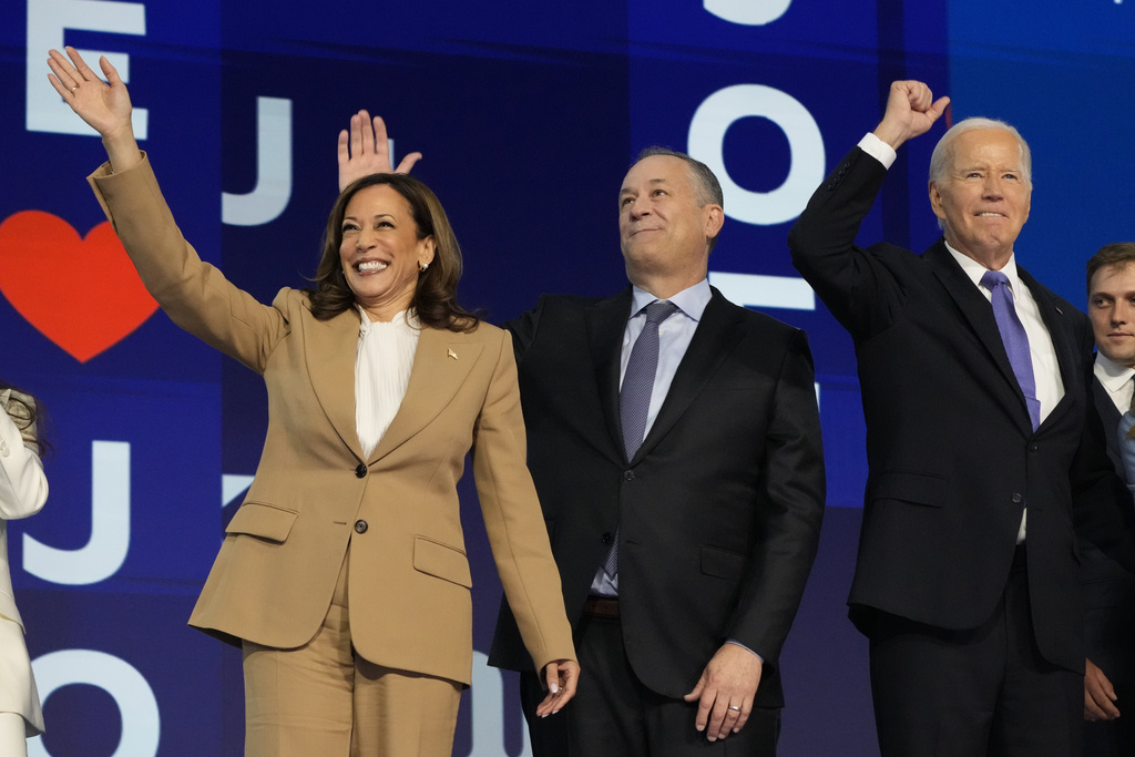 President Joe Biden waves with Democratic presidential nominee Vice President Kamala Harris and second gentleman Doug Emhoff during the first day of Democratic National Convention, Monday, Aug. 19, 2024, in Chicago. (AP Photo/Jacquelyn Martin)
