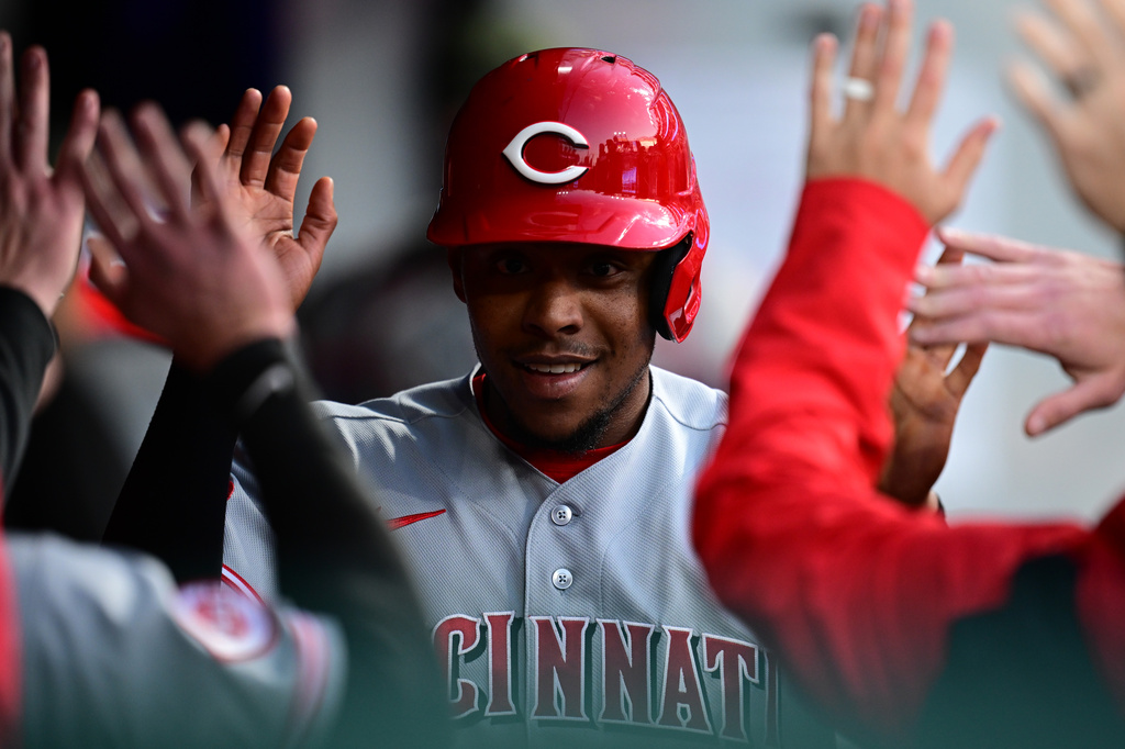 Cincinnati Reds third baseman Ke'bryan Hayes is congratulated in the dugout after scoring a run on an RBI double by Elly de la Cruz during the fifth inning of a baseball game against the Cleveland Guardians, Friday, May 15, 2026, in Cleveland. (AP Photo/David Dermer)