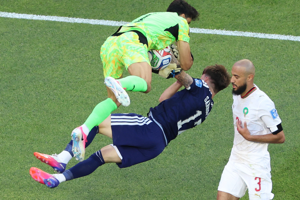 Morocco goalkeeper Yassine Bounou (1) collides with Scotland's Ben Gannon-Doak (17) during the World Cup Group C soccer match between Scotland and Morocco in Foxborough, Mass., near Boston, Friday, June 19, 2026. (AP Photo/Mark Stockwell)