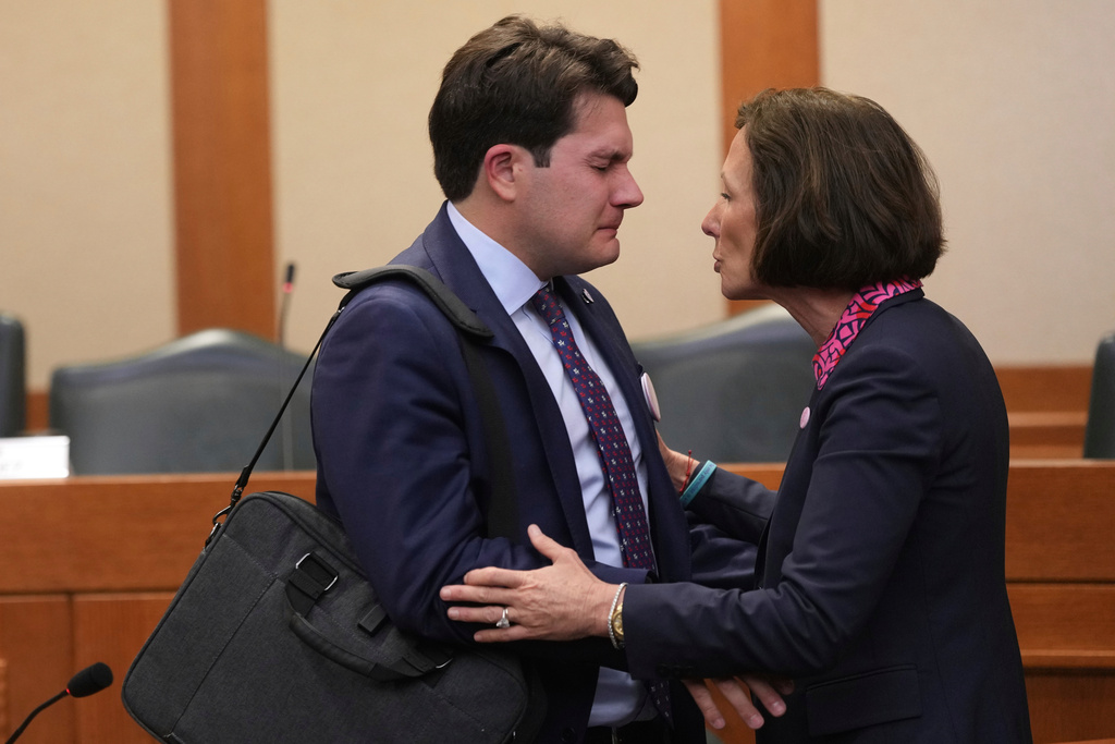 ADDS NAME OF FATHER Sen. Lois Kolkhorst, R-Brenham, right, comforts Lars Hollis, left, father of Virginia who was lost to the recent flooding in Kerr County, following a Texas Senate hearing at the Texas Capitol, Wednesday, Aug. 20, 2025, in Austin, Texas. (AP Photo/Eric Gay)