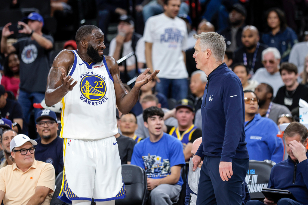 Golden State Warriors' Draymond Green (23) gestures to head coach Steve Kerr after being assessed a technical foul in the first half of an NBA play-in tournament basketball game against the Los Angeles Clippers in Inglewood, Calif., on Wednesday, April 15, 2026. (Carlos Avila Gonzalez/San Francisco Chronicle via AP)