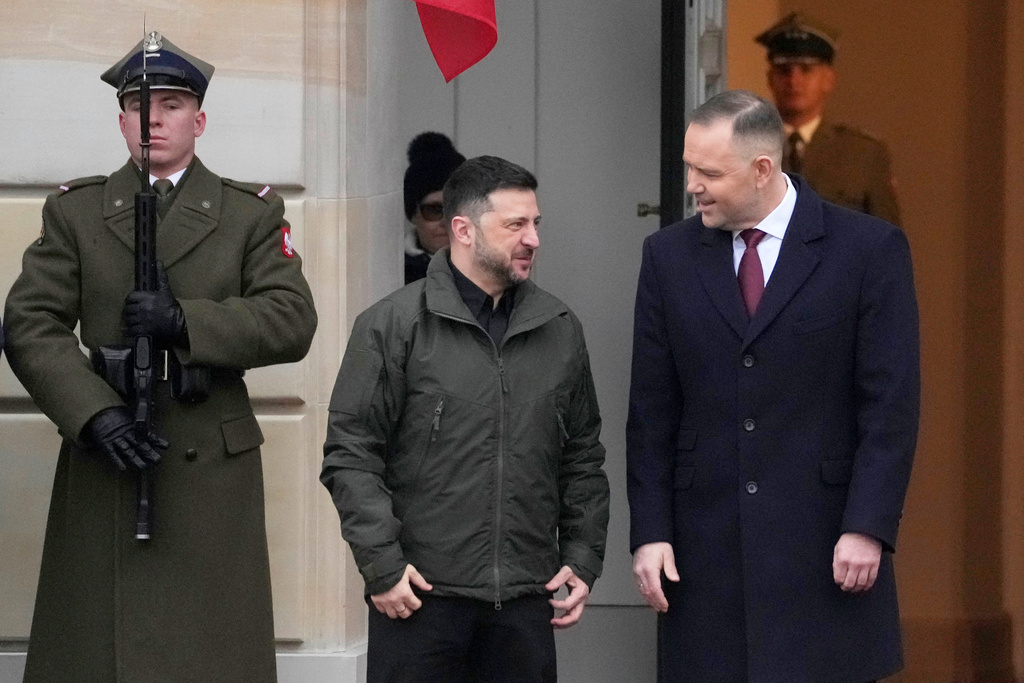 Polish President Karol Nawrocki, right, and Ukrainian President Volodymyr Zelenskyy attend an official welcome ceremony before their meeting at the Presidential Palace in Warsaw, Poland, Friday, Dec. 19, 2025. (AP Photo/Czarek Sokolowski)