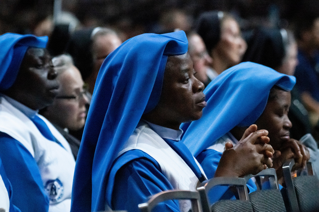 Attendees celebrate Communion at the beatification of Archbishop Fulton J. Sheen, Thursday, Sept. 24, 2026, in St. Louis. (AP Photo/Kate Munsch)