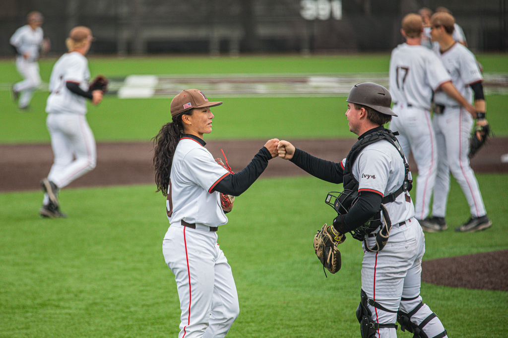 Brown University Olivia Pichardo fist bumps catcher Andrew Hanlon during a baseball game against Cornell Saturday, April 25, 2026, (Sage Hurteau/Brown Athletics via AP)