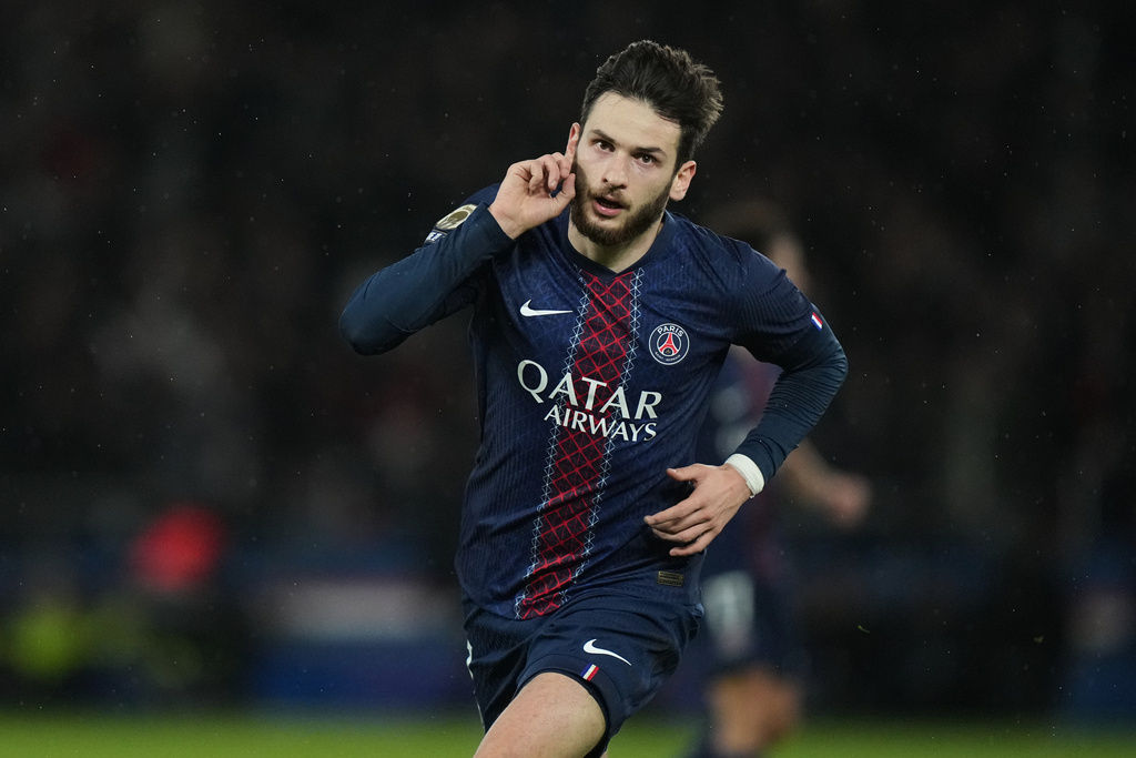 PSG's Khvicha Kvaratskhelia celebrates after scoring his side's first goal during the French League One soccer match between Paris and Rennes in Paris, France, Saturday, Dec. 6, 2025. (AP Photo/Thibault Camus)