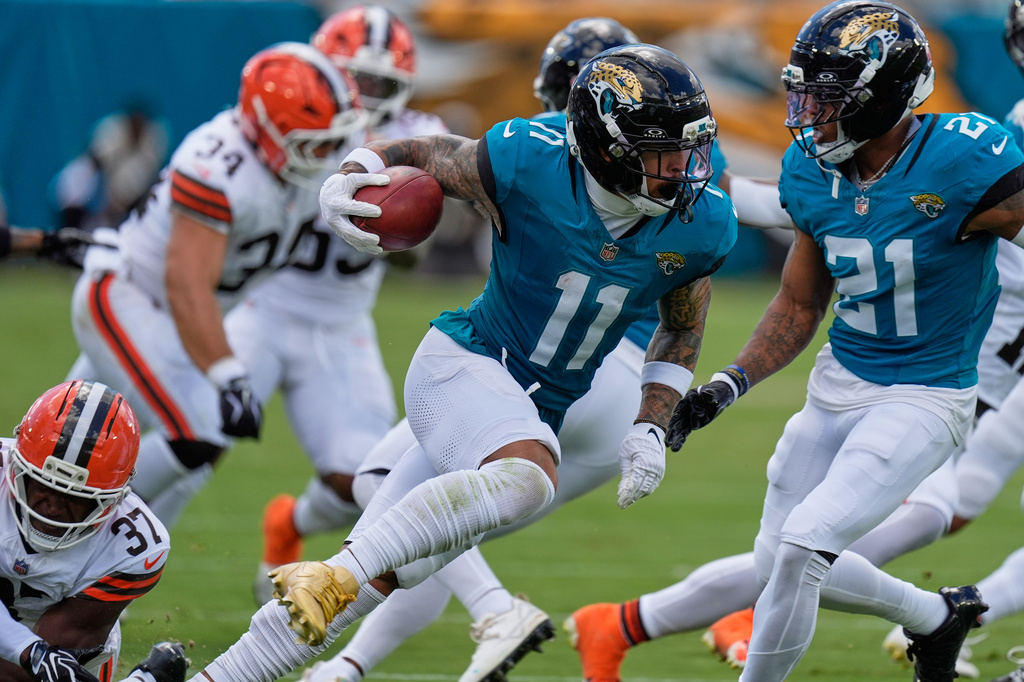 Jacksonville Jaguars wide receiver Parker Washington (11) carries in the first half of an NFL football game against the Cleveland Browns, Sunday, Sept. 13, 2026, in Jacksonville. (AP Photo/Mike Stewart)