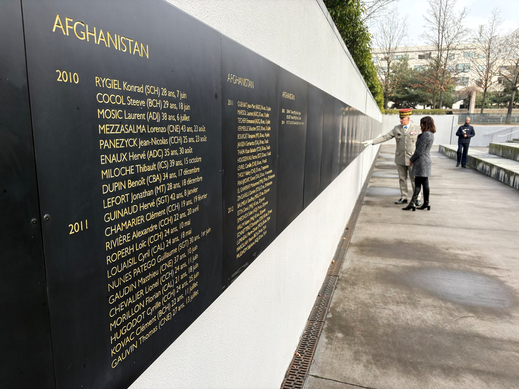 Alice Rufo, a deputy French defense minister, and Gen. Loic Mizon, the military governor of Paris, inspect the names of French troops killed in NATO operations in Afghanistan, where they fought with U.S. and other allied forces, during a visit Monday, Jan. 26, 2026, to a memorial in Paris for French troops killed in operations overseas. (AP Photo/John Leicester)
