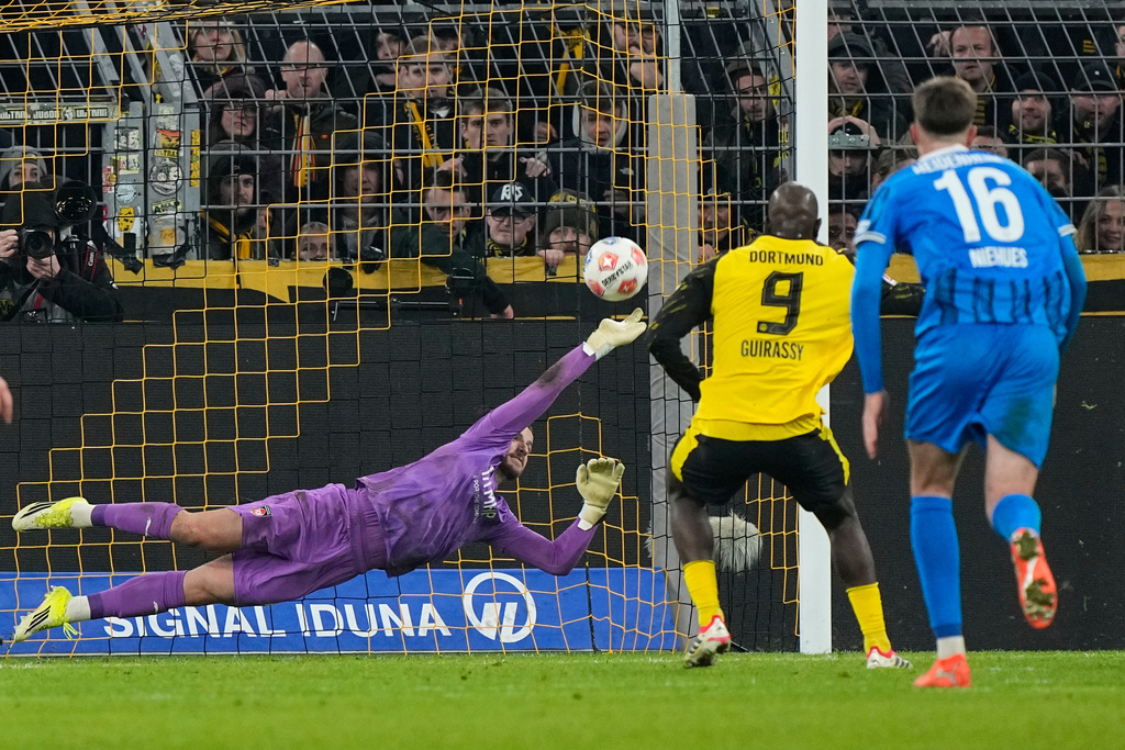 Dortmund's Serhou Guirassy scores his side's second goal from the penalty spot against Heidenheim's goalkeeper Diant Ramaj during the German Bundesliga soccer match between Borussia Dortmund and FC Heidenheim in Dortmund, Germany, Sunday, Feb. 1, 2026. (AP Photo/Martin Meissner)