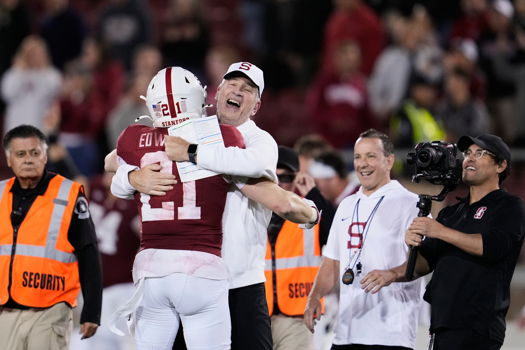 Stanford head coach Frank Reich, center right, celebrates with safety Scotty Edwards (21) after the team's victory over Florida State in an NCAA college football game, Saturday, Oct. 18, 2025, in Stanford, Calif. (AP Photo/Godofredo A. Vásquez)