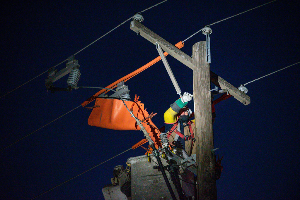 FILE - Oncor apprentice lineman Brendan Waldon repairs a utility pole that was damaged by a winter storm on Feb. 18, 2021, in Odessa, Texas. (Eli Hartman/Odessa American via AP, File)