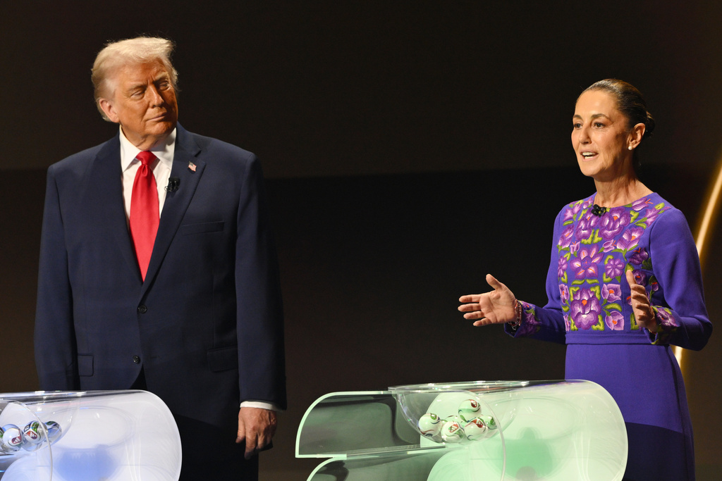 FILE - U.S. President Donald Trump looks on as Mexican President Claudia Sheinbaum speaks on stage at the draw for the 2026 soccer World Cup at the Kennedy Center in Washington, Dec. 5, 2025. (Mandel Ngan/Pool Photo via AP, File)