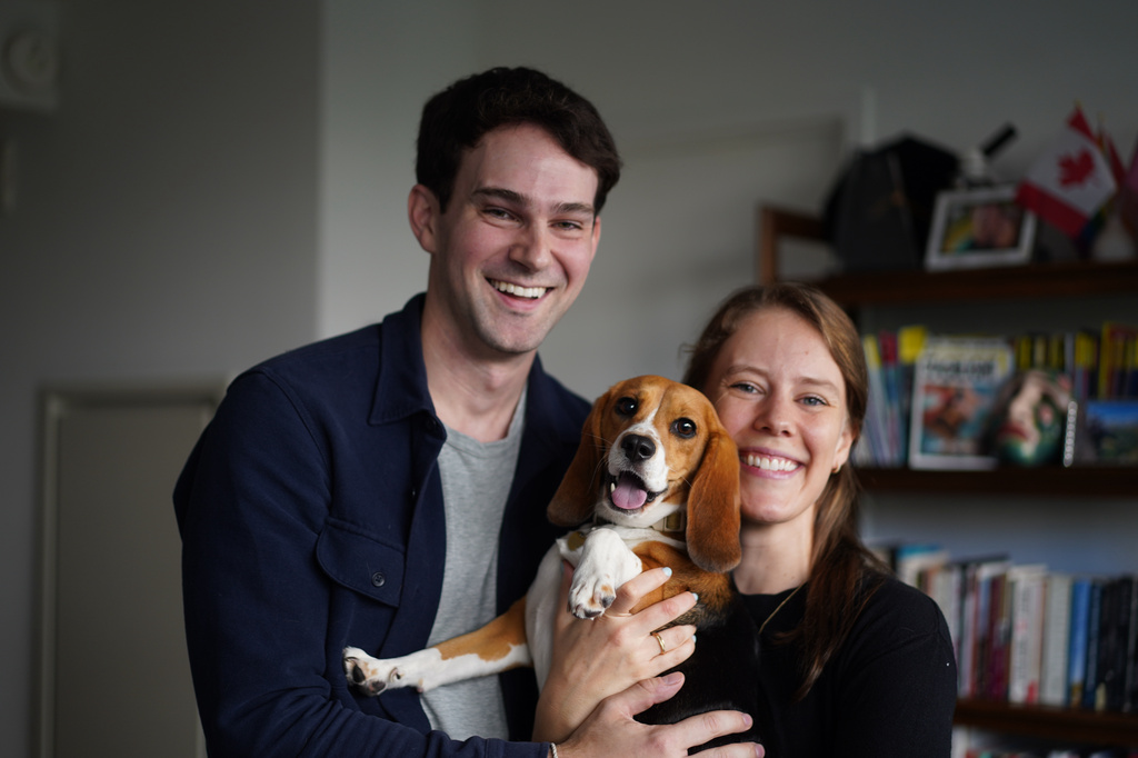 Matt and Maggie Walker pose for a photo with their gene-edited hypoallergenic beagle, Bailey, in New York on Aug. 4, 2026. (AP Photo/Mary Conlon)