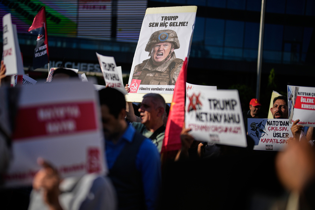 Demonstrators chant slogans and raise placards, including a sign depicting U.S. President Donald Trump, during an anti-NATO protest in Istanbul, Turkey, Saturday, June 27, 2026, days ahead of the NATO summit scheduled to be held in Ankara on July 7-8.(AP Photo/Khalil Hamra)