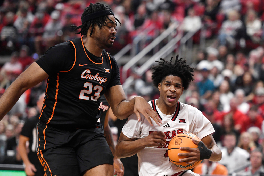 Oklahoma State center Benjamin Ahmed (23) fouls Texas Tech guard Christian Anderson (4) during the first half in an NCAA college basketball game, Saturday, Jan. 3, 2026, in Lubbock, Texas. (AP Photo/Annie Rice)