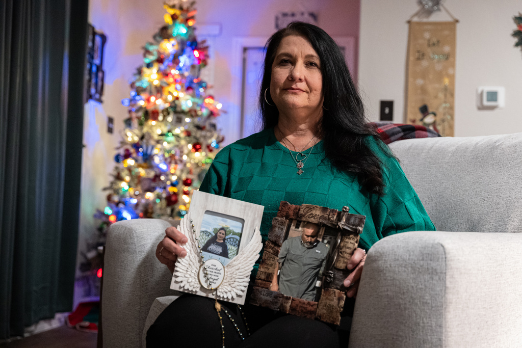 Velma Lisa Duran, sister of Robb Elementary teacher Irma Garcia, poses with photos of her sister and brother-in-law, Joe Garcia, as she reflects on the 2022 Uvalde, Texas, school shooting on Dec. 19, 2025, in San Antonio. (AP Photo/Kin Man Hui)