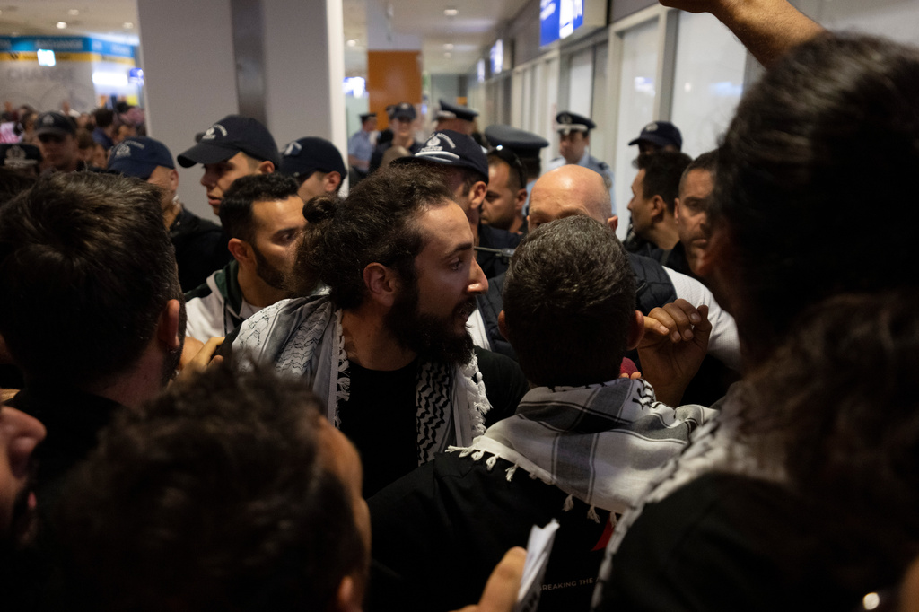 An activist from the Global Sumud Flotilla talks with the police upon his arrival at Eleftherios Venizelos International Airport in Athens, Greece, Friday, May 22, 2026. (AP Photo/Michael Varaklas)