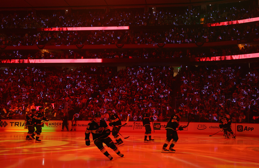 Members of the Minnesota Wild take to the ice before the home opener against the Columbus Blue Jackets in an NHL hockey game Saturday, Oct. 11, 2025, in St. Paul, Minn. (AP Photo/Adam Bettcher)