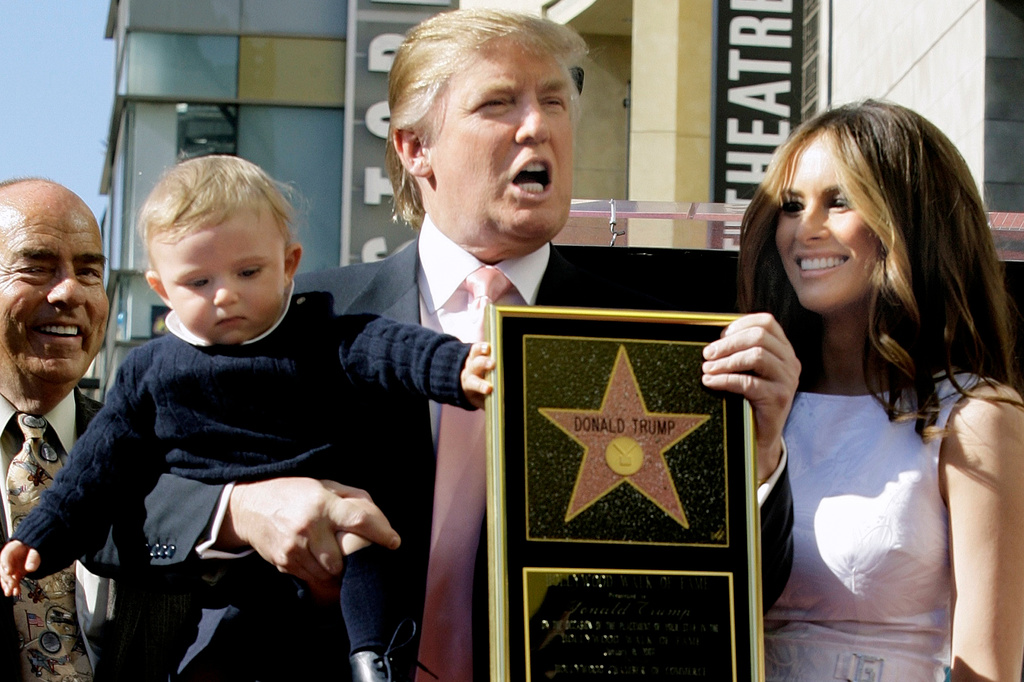 FILE - Donald Trump, the billionaire developer and producer of NBC's, "The Apprentice," with his wife, Melania Knauss, and their son, Barron, pose for a photo after he was honored with a star on the Hollywood Walk of Fame in Los Angeles, Jan. 16, 2007. (AP Photo/Damian Dovarganes, File)