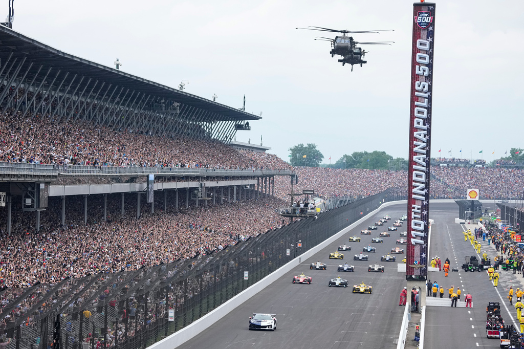 Helicopters fly over the field on the parade lap before the Indianapolis 500 auto race at Indianapolis Motor Speedway in Indianapolis, Sunday, May 24, 2026. (AP Photo/Michael Conroy)