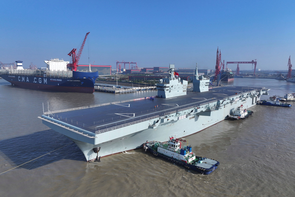 In this photo released by Xinhua News Agency, China's first Type 076 amphibious assault ship, PLANS Sichuan, sets sail from the port of Hudong-Zhonghua Shipbuilding (Group) Co., Ltd. in Shanghai on Friday, Nov. 14, 2025.(Zhang Liang/Xinhua via AP)