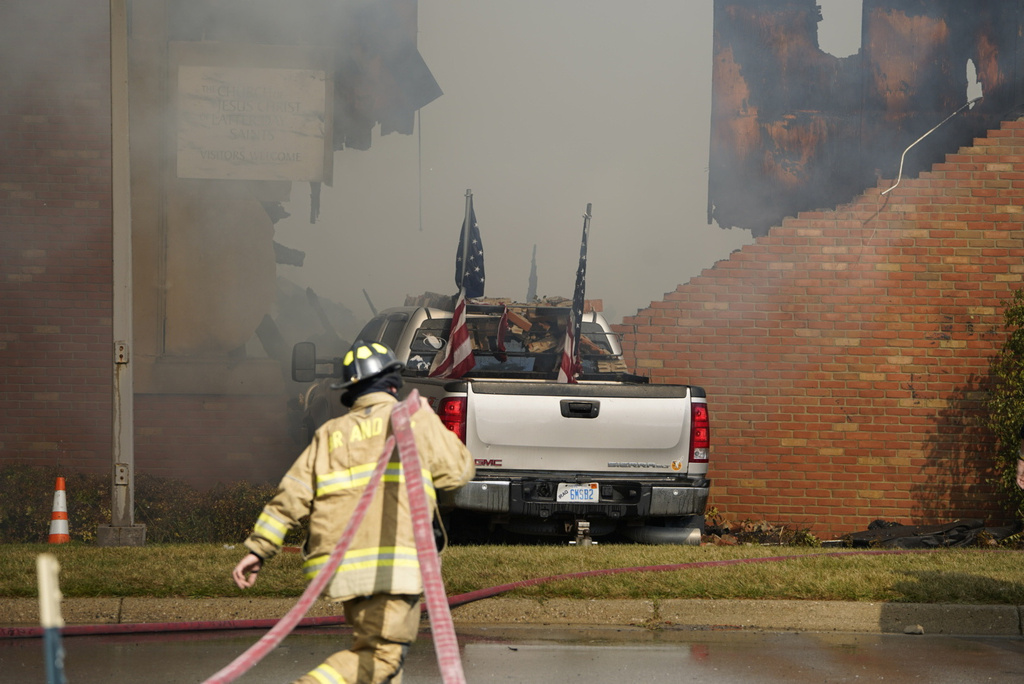 FILE - Firefighters work on the scene of a fire and shooting at the Church of Jesus Christ of Latter-day Saints in Grand Blanc, Mich., Sunday, Sept. 28, 2025. (Lukas Katilius/The Flint Journal via AP, File)