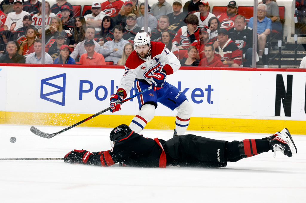 Carolina Hurricanes' K'andre Miller (19) slides to the ice to attempt to block a pass by Montréal Canadiens' Josh Anderson (17) during the first period in Game 1 of the Eastern Conference finals NHL hockey Stanley Cup playoffs series in Raleigh, N.C., Thursday, May 21, 2026. (AP Photo/Karl DeBlaker)