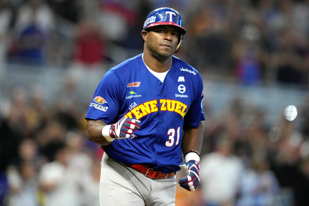 FILE - Venezuela's Yasiel Puig heads to first after drawing a bases loaded walk to score Ehire Adrianza during the third inning of a Caribbean Series baseball game against Curacao, Saturday, Feb. 3, 2024, in Miami. (AP Photo/Lynne Sladky, File)