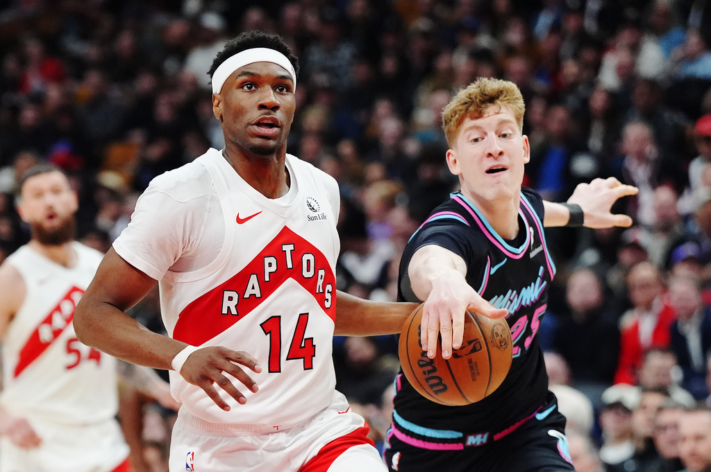 Miami Heat's Kasparas Jakucionis, right, strips the ball from Toronto Raptors' Ja'kobe Walter (14) during the first half of an NBA basketball game in Toronto on Tuesday, April 7, 2026. (Frank Gunn/The Canadian Press via AP)