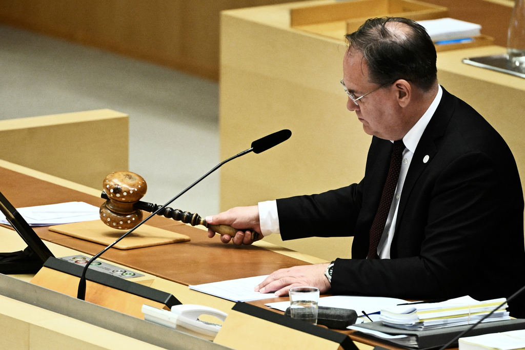 Vice Speaker Kenneth G. Forslund gavels as the Swedish parliament (Riksdagen) votes on new justice legislation in Stockholm, Monday, June 15, 2026. (Fredrik Sandberg/TT News Agency via AP)