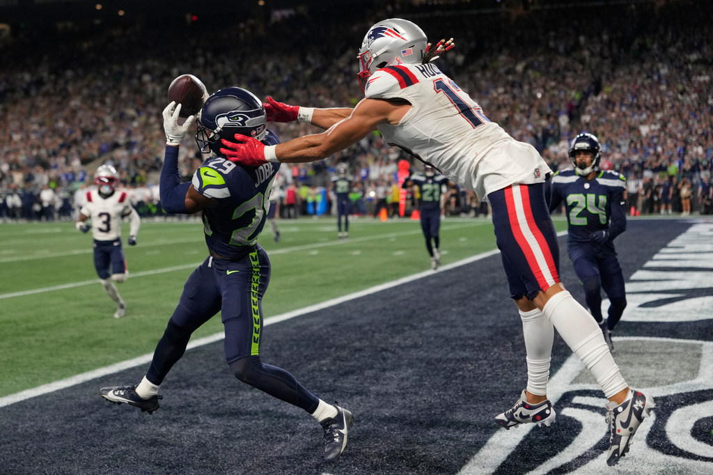 Seattle Seahawks cornerback Josh Jobe (29) intercepts a pass in the end zone intended for New England Patriots wide receiver Mack Hollins (13) during the second half of an NFL football game, Wednesday, Sept. 9, 2026, in Seattle. (AP Photo/Stephen Brashear)