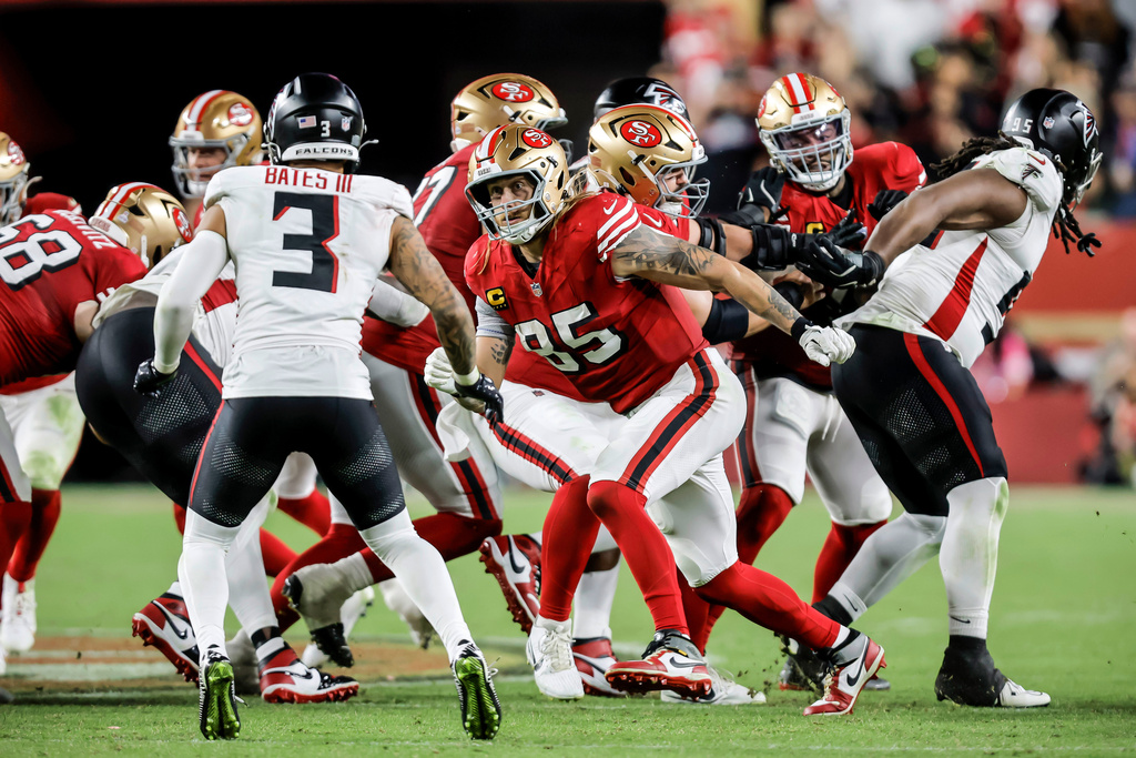 San Francisco 49ers' George Kittle (85) blocks for teammate Christian McCaffrey in the second half of an NFL football game against the Atlanta Falcons in Santa Clara, Calif., on Sunday, Oct. 19, 2025. (Carlos Avila Gonzalez/San Francisco Chronicle via AP)