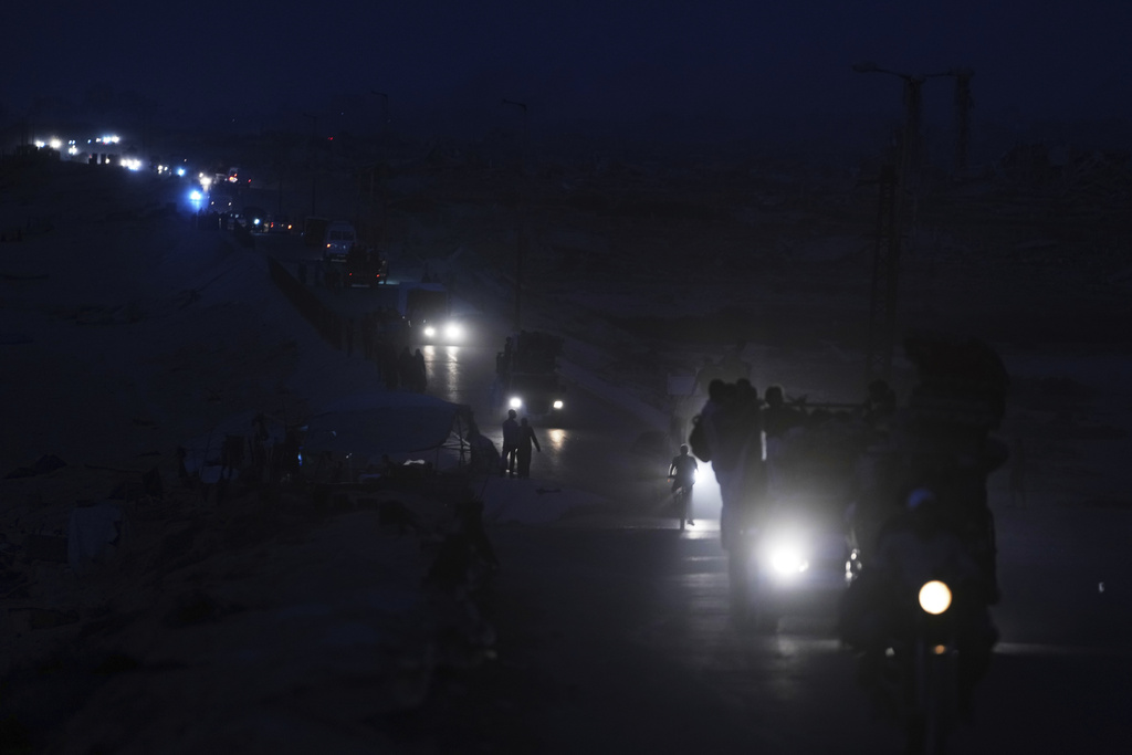 Displaced Palestinians fleeing northern Gaza carry their belongings along the coastal road toward southern Gaza, Saturday, Sept. 6, 2025. (AP Photo/Jehad Alshrafi)