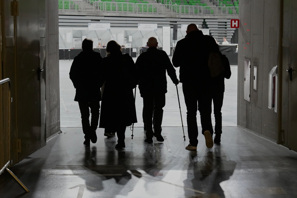 Voters arrive to a sports hall turned polling station for early vote in Ljubljana, Slovenia, Wednesday, March 18, 2026. (AP Photo/Darko Bandic)