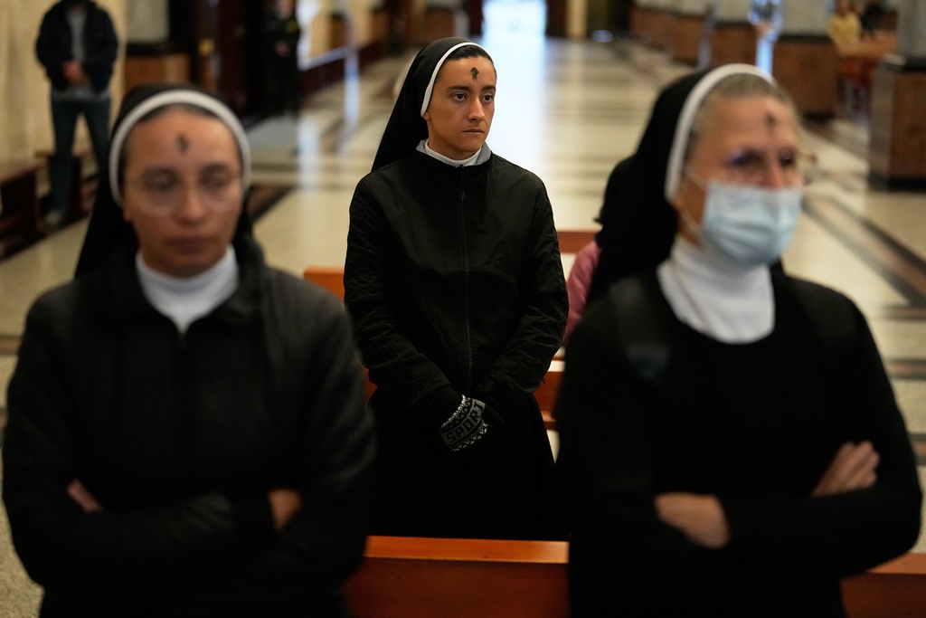 Nuns attend Ash Wednesday Mass after getting the form of a cross marked on their foreheads at the Divine Child Church in Bogota, Colombia, Wednesday, Feb. 18, 2026, the start of the Christian season of Lent, a period of penitence and reflection that leads up to Easter. (AP Photo/Fernando Vergara)