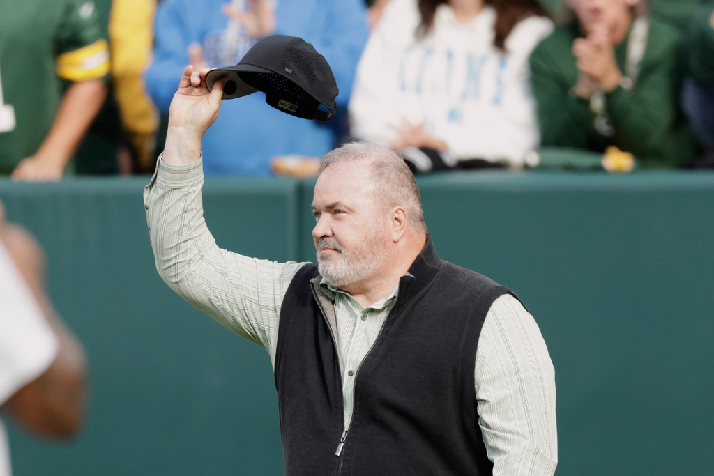FILE - Former Green Bay Packers head coach Mike McCarthy waves during halftime of an NFL football game against the Detroit Lions Sunday, Sept. 7, 2025, in Green Bay, Wis. (AP Photo/Matt Ludtke, File)