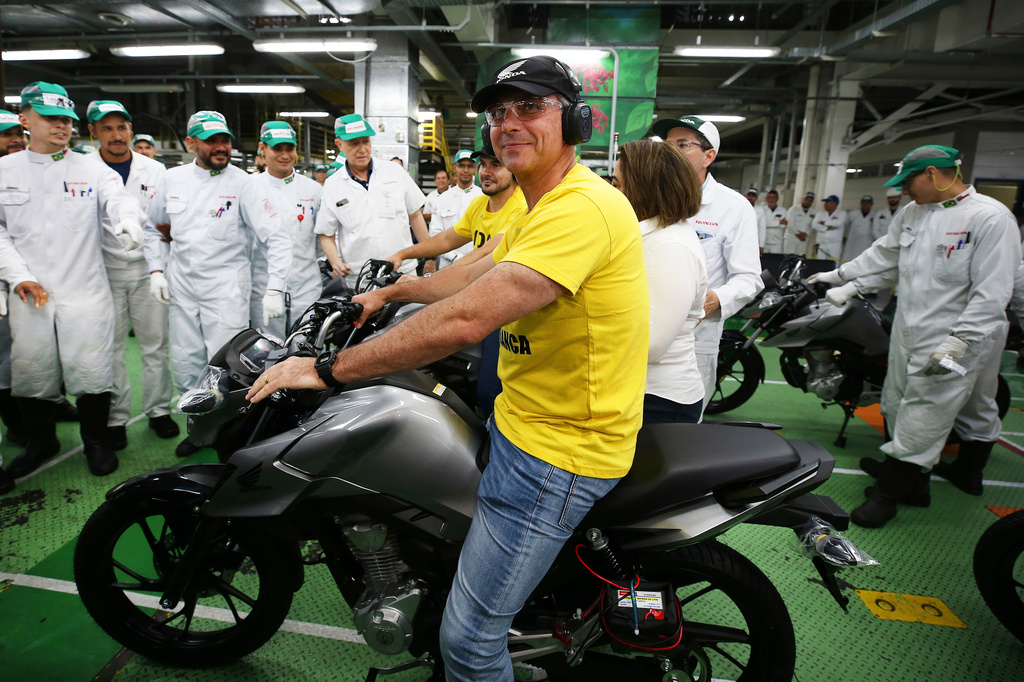 Opposition presidential candidate Sen. Flavio Bolsonaro sits on a motorcycle during a visit to a Honda motorcycle factory in the Manaus Free Trade Zone during a campaign event in Manaus, Amazonas state, Brazil, Friday, Sept. 11, 2026. (AP Photo/Edmar Barros)