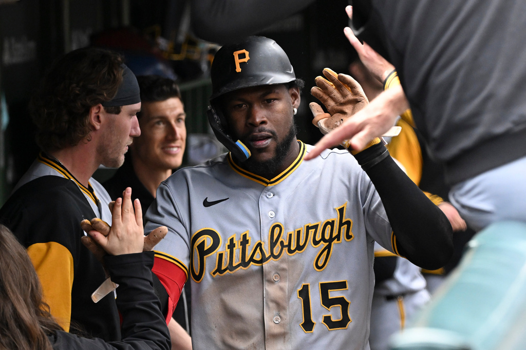 Pittsburgh Pirates' Oneil Cruz (15) celebrates in the dugout after scoring against the Chicago Cubs during the third inning of a baseball game, Saturday, April 11, 2026, in Chicago. (AP Photo/Matt Marton)