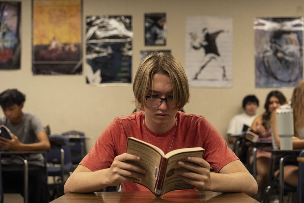 Timothy Rimke reads during Casey Cuny's English class at Valencia High School in Santa Clarita, Calif., Wednesday, Aug. 27, 2025. (AP Photo/Jae C. Hong)