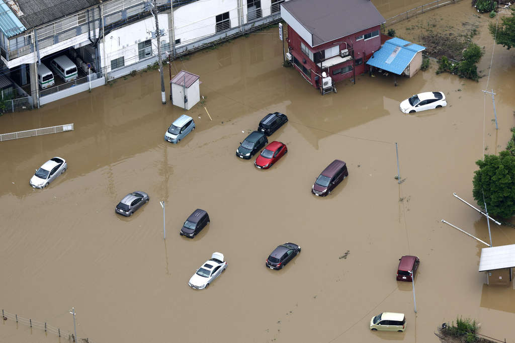 This aerial photo shows submerged cars after heavy rain in Oamishirasato, Chiba prefecture, Japan, Friday, Aug. 14, 2026. (Kota Endo/Kyodo News via AP)
