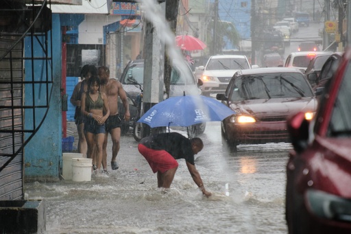 People walk in a street flooded by rains caused by Tropical Storm Melissa in Santo Domingo, Dominican Republic, Friday, Oct. 24, 2025. (AP Photo/Ricardo Hernandez) People walk in a street flooded by rains caused by Tropical Storm Melissa in Santo Domingo, Dominican Republic, Friday, Oct. 24, 2025. (AP Photo/Ricardo Hernandez)