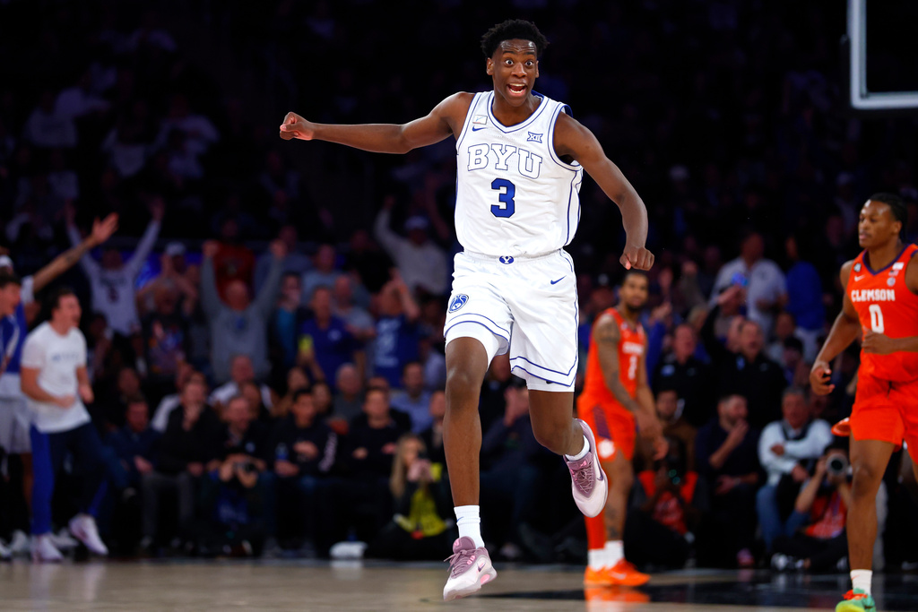 BYU forward AJ Dybantsa (3) reacts after a dunk by teammate Keba Keita during the second half of an NCAA basketball game against Clemson, Tuesday, Dec. 9, 2025, in New York. (AP Photo/Noah K. Murray)