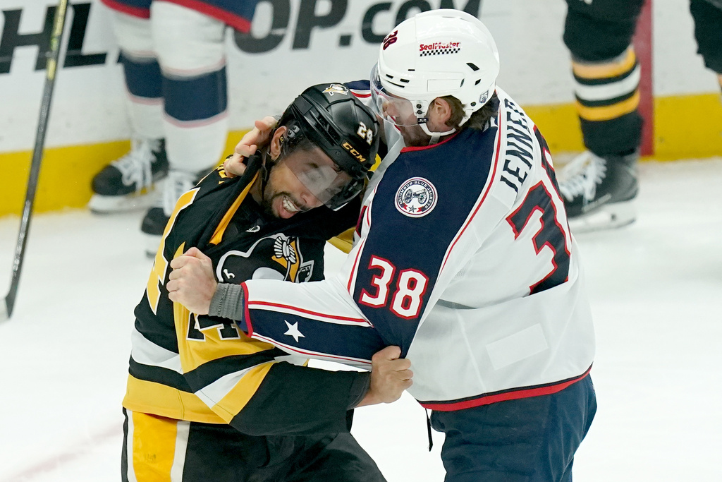 Pittsburgh Penguins' Mathew Dumba, left, fights Columbus Blue Jackets' Boone Jenner (38) during the first period of an NHL hockey game, Saturday, Oct. 25, 2025, in Pittsburgh. (AP Photo/Matt Freed)