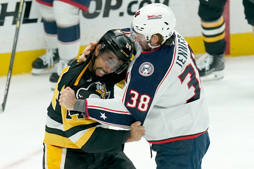 Pittsburgh Penguins' Mathew Dumba, left, fights Columbus Blue Jackets' Boone Jenner (38) during the first period of an NHL hockey game, Saturday, Oct. 25, 2025, in Pittsburgh. (AP Photo/Matt Freed) Pittsburgh Penguins' Mathew Dumba, left, fights Columbus Blue Jackets' Boone Jenner (38) during the first period of an NHL hockey game, Saturday, Oct. 25, 2025, in Pittsburgh. (AP Photo/Matt Freed)
