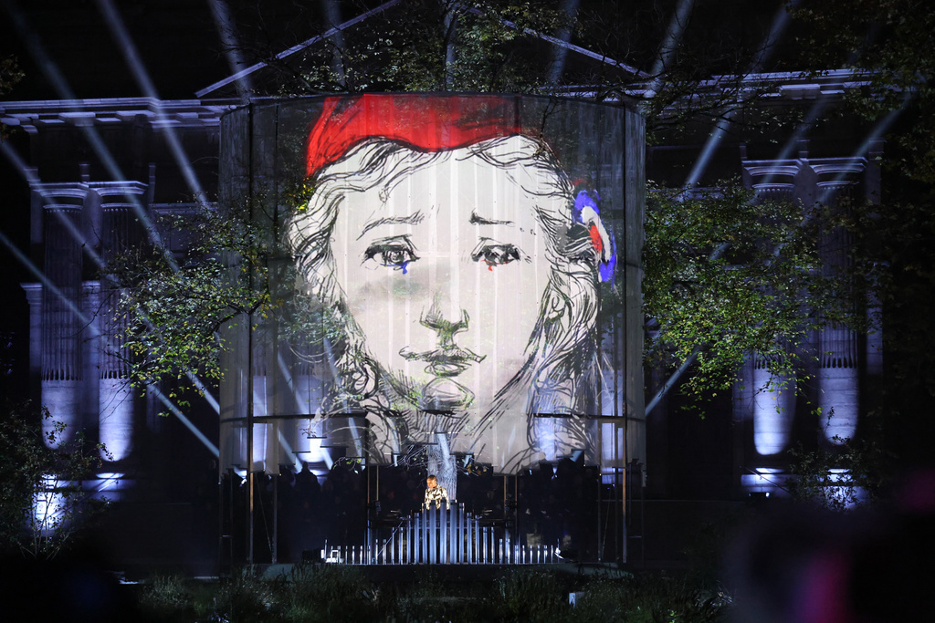 A DJ performs at the "Jardin du 13 novembre 2015" inaugurated Thursday Nov. 13, 2025 in Paris as part of ceremonies marking the 10th anniversary of terrorist attacks that killed 132 people and injured hundreds. (Ludovic Marin, Pool photo via AP)
