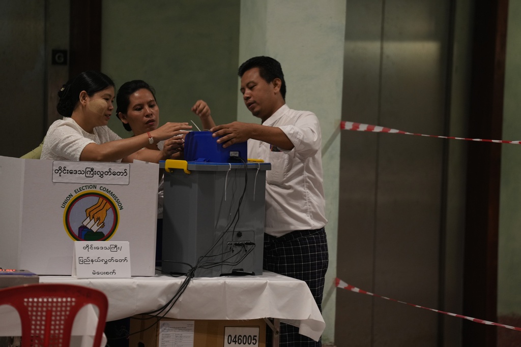 Election volunteers prepare to open a polling station, Sunday, Dec. 28, 2025, in Yangon, Myanmar. (AP Photo/Thein Zaw)