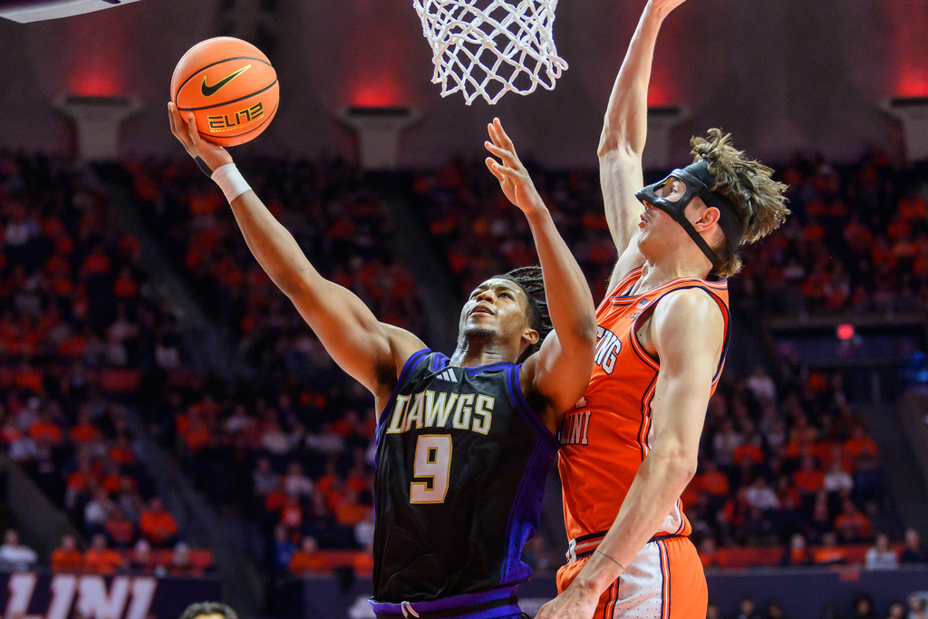 Washington guard Wesley Yates III (9) goes up to the basket against Zvonimir Ivisic during the second half of an NCAA college basketball game against Illinois Thursday, Jan. 29, 2026, in Champaign, Ill. (AP Photo/Craig Pessman)